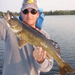 Man Posing with a Walleye Fish