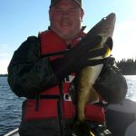 Man posing with a walleye fish