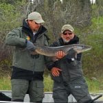 2 friends holding a pike