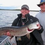 Man holding a pike fish
