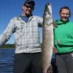 Father and daughter with a pike