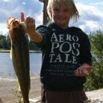 Child posing with huge walleye catch