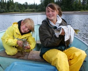 2 kids posing with walleye fish