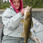 Boy posing with a walleye fish